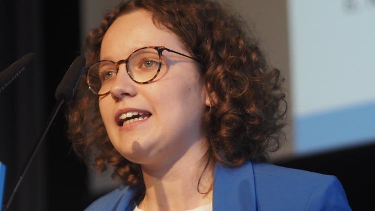 Anna Ortwein während ihrer Rede im blauen Blazer und weißer Bluse